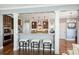 Well-appointed kitchen with a bar-style seating area, complemented by stainless steel appliances and a view of the Gathering room at 4941 Campobello Dr, Monroe, NC 28110