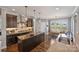 Spacious kitchen featuring granite countertops, a center island, dark wood cabinetry, and an adjacent eat-in dining space at 4941 Campobello Dr, Monroe, NC 28110