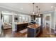 Modern kitchen with a center island, stainless steel appliances, and an adjacent living room for easy entertaining at 4941 Campobello Dr, Monroe, NC 28110
