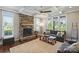 Cozy living room with a stone fireplace, coffered ceiling, and large windows with backyard views at 4941 Campobello Dr, Monroe, NC 28110