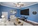 Stylish living room with a large TV, modern entertainment system, and a comfortable armchair at 4941 Campobello Dr, Monroe, NC 28110