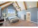 Spacious main bedroom with vaulted ceilings, exposed beams, a ceiling fan, and large arched windows at 4941 Campobello Dr, Monroe, NC 28110