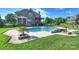 Backyard pool with a pergola, outdoor seating, stone accents, and a lush green lawn at 4941 Campobello Dr, Monroe, NC 28110