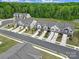 Overhead shot of a neighborhood featuring townhomes with driveways, landscaping, and green spaces at 5034 Moss Pine Way, Tega Cay, SC 29708