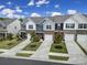 Aerial view of townhomes featuring brick facades, attached garages, driveways and landscaping at 5034 Moss Pine Way, Tega Cay, SC 29708
