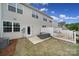 View of a backyard with a small patio and outdoor seating adjacent to the home's exterior at 5034 Moss Pine Way, Tega Cay, SC 29708