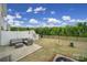 View of a fenced backyard featuring a patio with outdoor seating and a partial view of a home's exterior at 5034 Moss Pine Way, Tega Cay, SC 29708