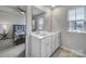 Bright bathroom with double sinks and access to the bedroom and shower at 5034 Moss Pine Way, Tega Cay, SC 29708