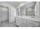 Bright bathroom featuring double sink vanity with modern hardware, neutral tile flooring, and glass enclosed shower at 5034 Moss Pine Way, Tega Cay, SC 29708