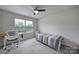 Bedroom with gray carpet, ceiling fan, a desk, and a window at 5034 Moss Pine Way, Tega Cay, SC 29708
