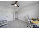 Bedroom with gray carpet, ceiling fan, a desk, and double door closet at 5034 Moss Pine Way, Tega Cay, SC 29708