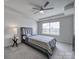Comfortable bedroom with ceiling fan and ample natural light from the window at 5034 Moss Pine Way, Tega Cay, SC 29708