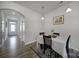 Dining area with wood table set on an area rug, and view to a spacious living area at 5034 Moss Pine Way, Tega Cay, SC 29708