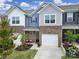 Charming townhome with brick accents, a one-car garage, and a beautifully landscaped front yard at 5034 Moss Pine Way, Tega Cay, SC 29708