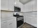 Well-lit kitchen featuring white cabinets, stainless steel appliances, and a gas range stove at 5034 Moss Pine Way, Tega Cay, SC 29708