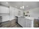 Contemporary kitchen featuring white cabinetry, an island with a sink, and modern appliances at 5034 Moss Pine Way, Tega Cay, SC 29708