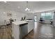 Open-concept kitchen flows into a dining and living area, perfect for modern living at 5034 Moss Pine Way, Tega Cay, SC 29708