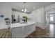 Bright kitchen with white cabinets, quartz countertops, and a convenient island at 5034 Moss Pine Way, Tega Cay, SC 29708