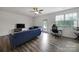 Bright living room with wood floors, fan, and access to the outdoor area at 5034 Moss Pine Way, Tega Cay, SC 29708