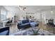 Open concept living room flowing into kitchen and dining areas at 5034 Moss Pine Way, Tega Cay, SC 29708