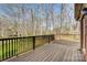 Spacious wooden back deck with metal railing overlooking a wooded lot at 5108 Tedorill Ln, Charlotte, NC 28226