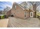 Brick home exterior featuring a wooden deck, ideal for outdoor entertaining and relaxation at 5108 Tedorill Ln, Charlotte, NC 28226