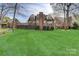 Manicured backyard and deck area highlight this home's exterior at 5108 Tedorill Ln, Charlotte, NC 28226