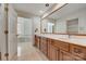 Bathroom with double sink vanity, large mirror, and a view into a separate tub room at 5108 Tedorill Ln, Charlotte, NC 28226