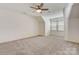 A cozy carpeted bedroom with large windows and a ceiling fan, offering ample natural light at 5108 Tedorill Ln, Charlotte, NC 28226