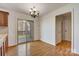 Bright dining area features hardwood floors, sliding glass door, and decorative chandelier at 5108 Tedorill Ln, Charlotte, NC 28226
