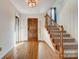 Welcoming foyer featuring hardwood floors, staircase, and natural light at 5108 Tedorill Ln, Charlotte, NC 28226