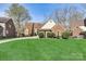 Charming brick home with well-manicured lawn, mature trees, and beautiful landscaping at 5108 Tedorill Ln, Charlotte, NC 28226