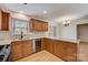 Well-lit kitchen features wood cabinets, countertops, and stainless steel appliances at 5108 Tedorill Ln, Charlotte, NC 28226