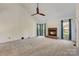 Bright living room featuring a fireplace, vaulted ceiling, and neutral carpet at 5108 Tedorill Ln, Charlotte, NC 28226