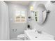 Bright bathroom featuring a white vanity, toilet, and classic shuttered window offering natural light at 5162 Lincrest Pl, Charlotte, NC 28211