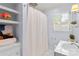 Fresh bathroom featuring a shower with curtain, window and floral decor at 5162 Lincrest Pl, Charlotte, NC 28211