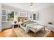 Bright bedroom with hardwood floors, white shutters, and a cozy rug at 5162 Lincrest Pl, Charlotte, NC 28211