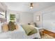 Comfortable bedroom with neutral decor, hardwood floors, and a cozy chaise lounge at 5162 Lincrest Pl, Charlotte, NC 28211