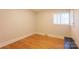 An empty bedroom with wood floors and window with blinds, ready for personalization and comfort at 5162 Lincrest Pl, Charlotte, NC 28211