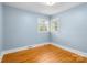 Comfortable bedroom with hardwood floors and window with shutters at 5162 Lincrest Pl, Charlotte, NC 28211