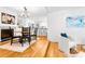 Bright open concept dining area with fireplace and hardwood floors adjacent to the kitchen and living room at 5162 Lincrest Pl, Charlotte, NC 28211