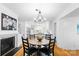 Open concept dining area featuring a fireplace and views of the kitchen and island seating at 5162 Lincrest Pl, Charlotte, NC 28211
