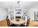 Charming dining area has a farmhouse style chandelier and a fireplace with built-in shelving at 5162 Lincrest Pl, Charlotte, NC 28211