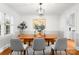 Elegant dining room with modern lighting, hardwood floors, and neutral tones perfect for entertaining at 5162 Lincrest Pl, Charlotte, NC 28211
