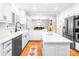 Stunning updated kitchen with stainless steel appliances, white countertops and cabinets, and hardwood floors at 5162 Lincrest Pl, Charlotte, NC 28211