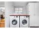 Convenient laundry room with front-load washer and dryer set, cabinets, and counter space at 5162 Lincrest Pl, Charlotte, NC 28211