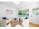 Cozy living room with large windows, hardwood floors, and comfortable seating; perfect for relaxing or entertaining at 5162 Lincrest Pl, Charlotte, NC 28211