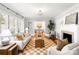 Bright living room with fireplace, hardwood floors, and a view into the adjacent dining area at 5162 Lincrest Pl, Charlotte, NC 28211