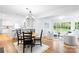 Open concept living and dining area features hardwood floors, large windows, and a seamless transition to the kitchen at 5162 Lincrest Pl, Charlotte, NC 28211