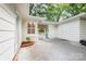Charming patio with white painted brick and wood, featuring a gated entrance and a small garden bed at 5162 Lincrest Pl, Charlotte, NC 28211